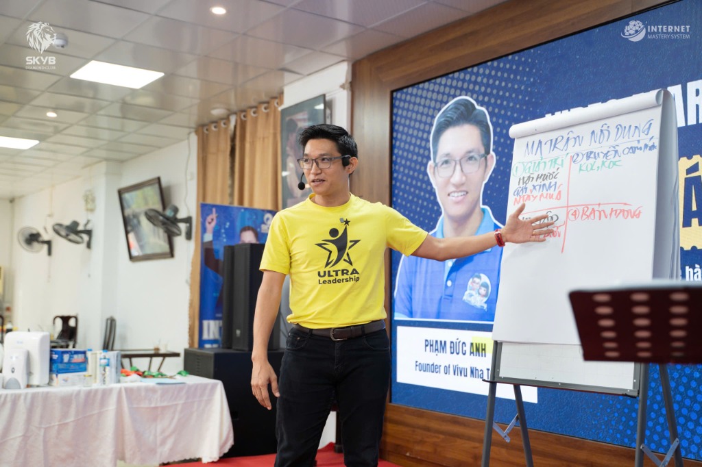 Phạm Đức Anh giảng dạy Ma trận Nội dung tại workshop ULTRA Leadership — áo vàng, whiteboard, SKVB